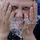 Un hombre refrescándose por las altas temperaturas. AP